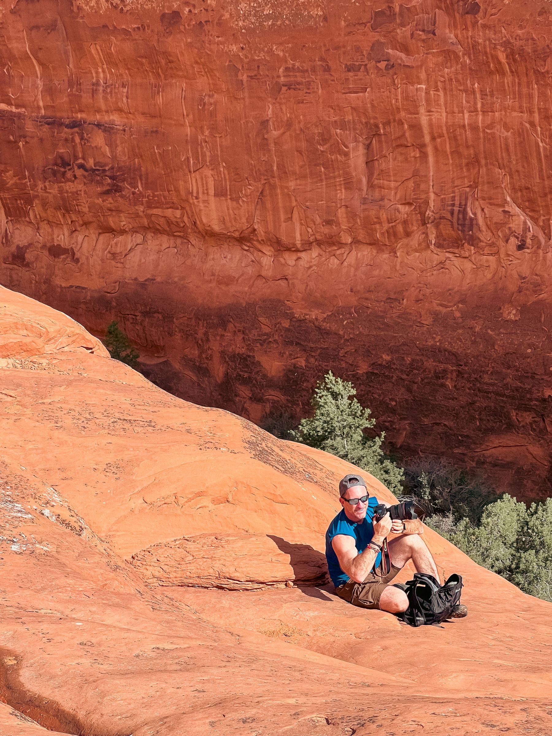 Ryan Sitting on Rock Escarpment with Camera